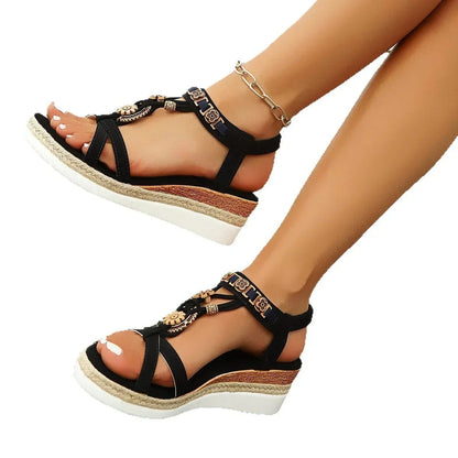 Black open-toe platform sandals with thick sole, gold floral charms and ankle bracelet