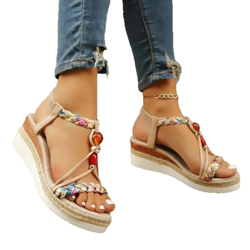 Apricot wedge sandals with braided straps, bead charms, and espadrille platform sole.
