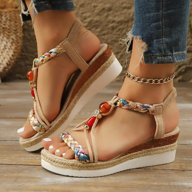 Apricot platform wedge sandals with braided straps, colorful trim, and bead accents.
