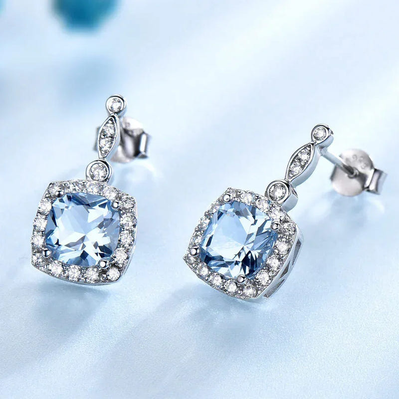 Sterling silver sky blue topaz stud earrings with cushion-cut center stones