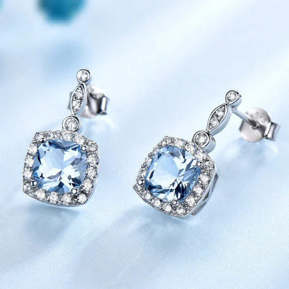 Sterling silver sky blue topaz stud earrings with cushion-cut center stones
