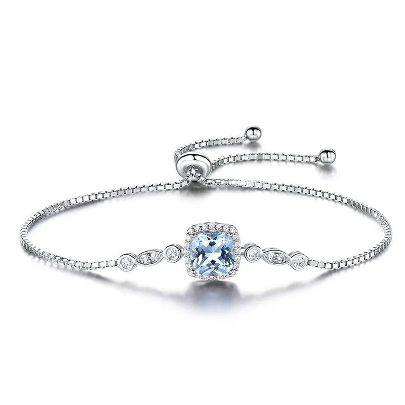 Sterling silver sky blue topaz bracelet with oval center stone and small halo accents