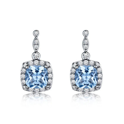 Sterling silver sky blue topaz earrings with cushion-cut center stone and clear stone halo