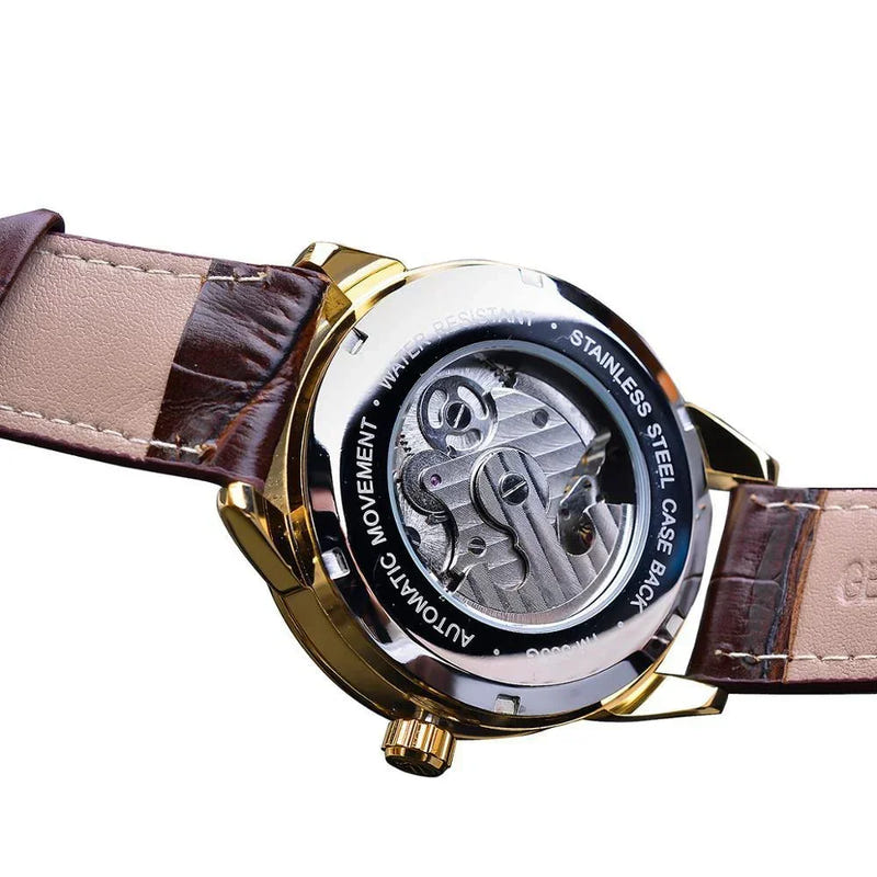 Mechanical skeleton watch, side view: gold case, brown leather strap, openwork movement