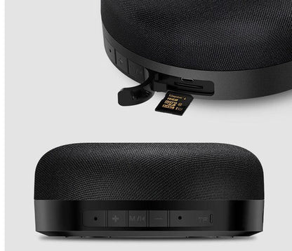 Black fabric Bluetooth speaker with control buttons and USB port on side panel