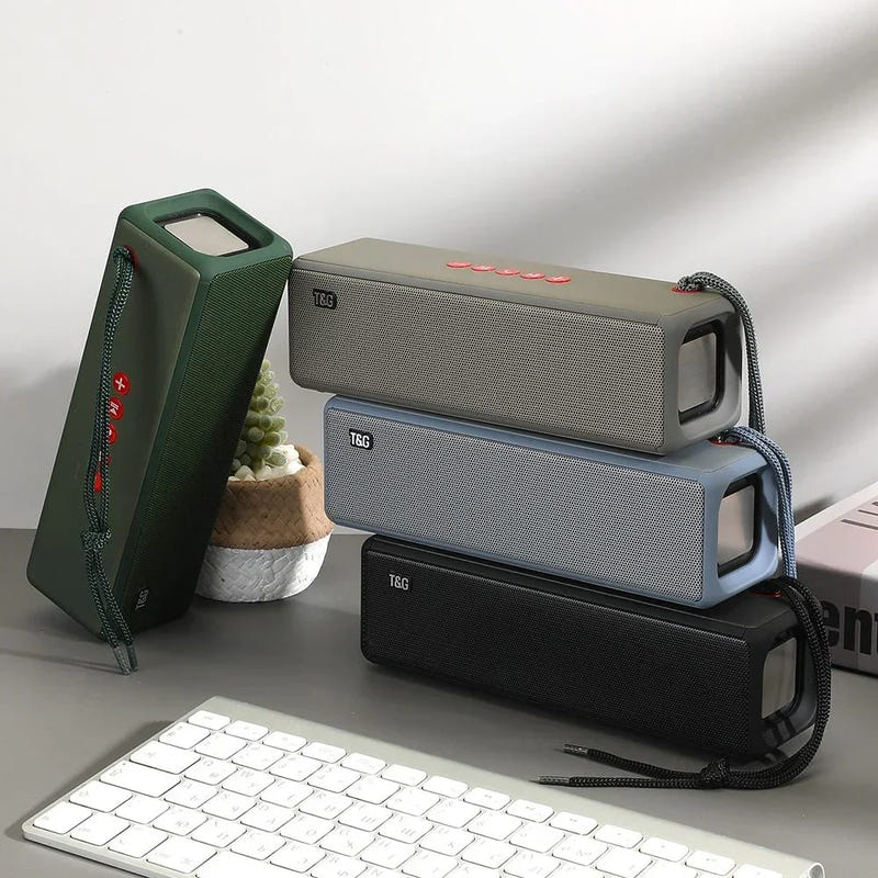 Portable square mini Bluetooth speaker with fabric grille, handle, and top controls