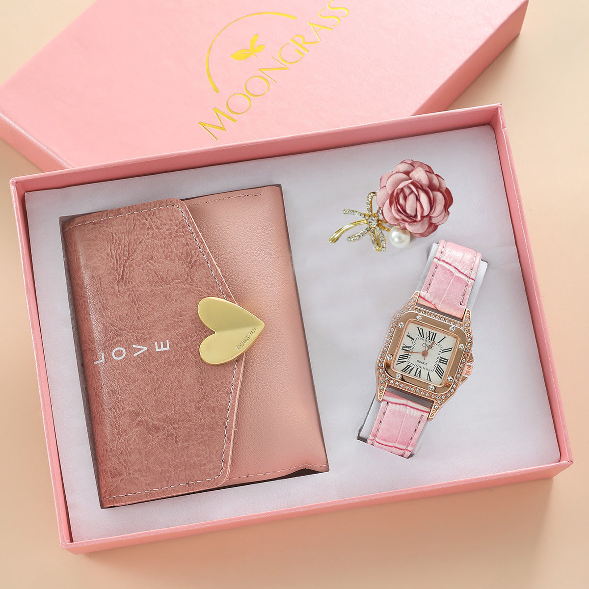 Pink watch and wallet set in a gift box with 'Moonchain' branding.