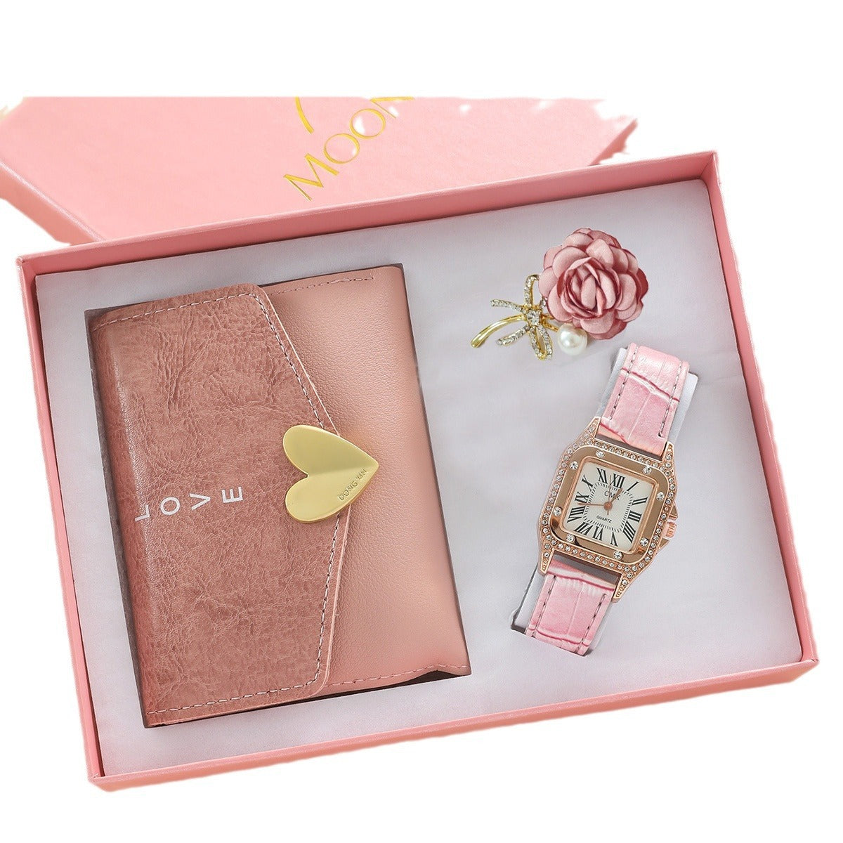 Pink watch and wallet set with decorative elements in a box