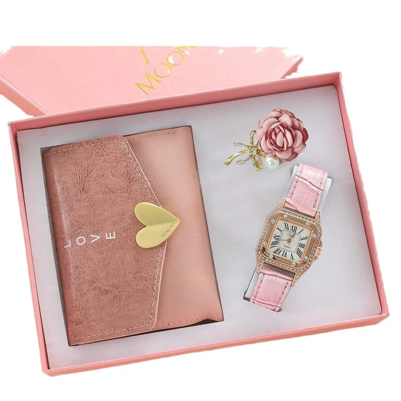 Open pink box gift set with brown wallet, pink strap watch, and rose brooch