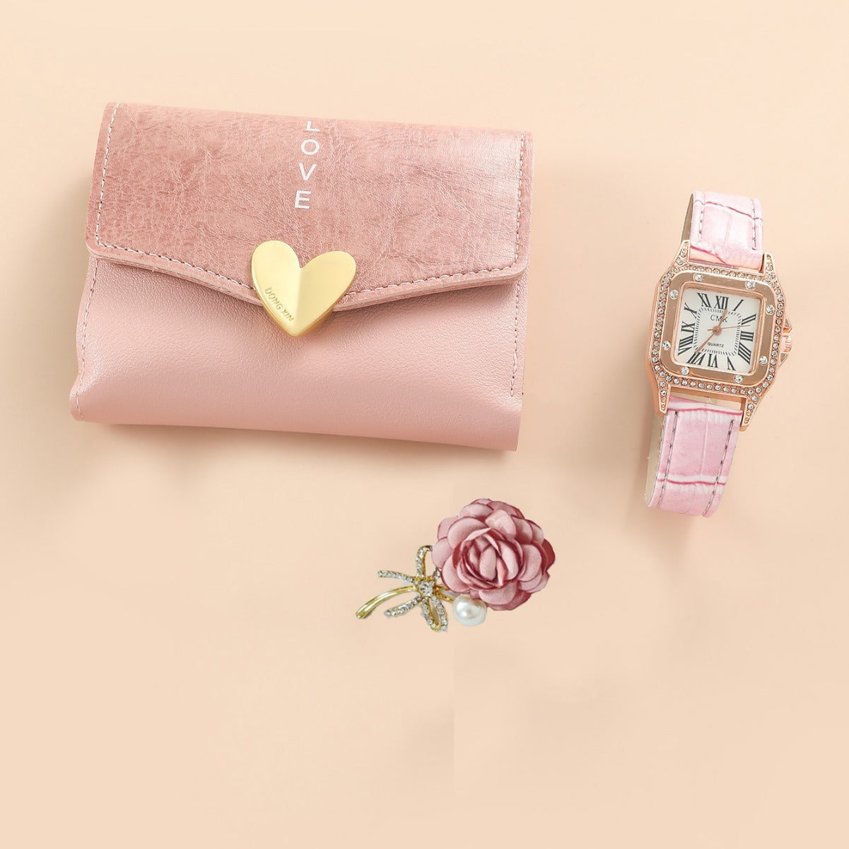 Pink wallet with gold heart, pink watch, and pink flower on a beige background