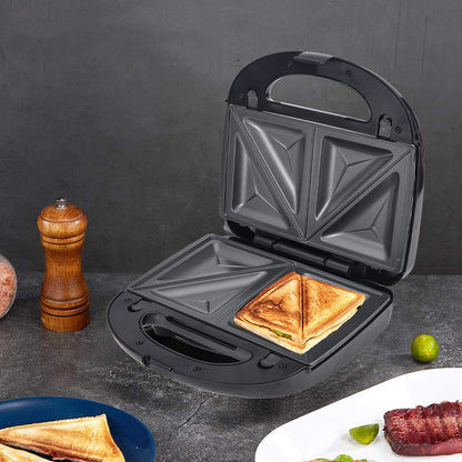 Black sandwich toaster with a toasted sandwich inside, on a dark surface with food items around.