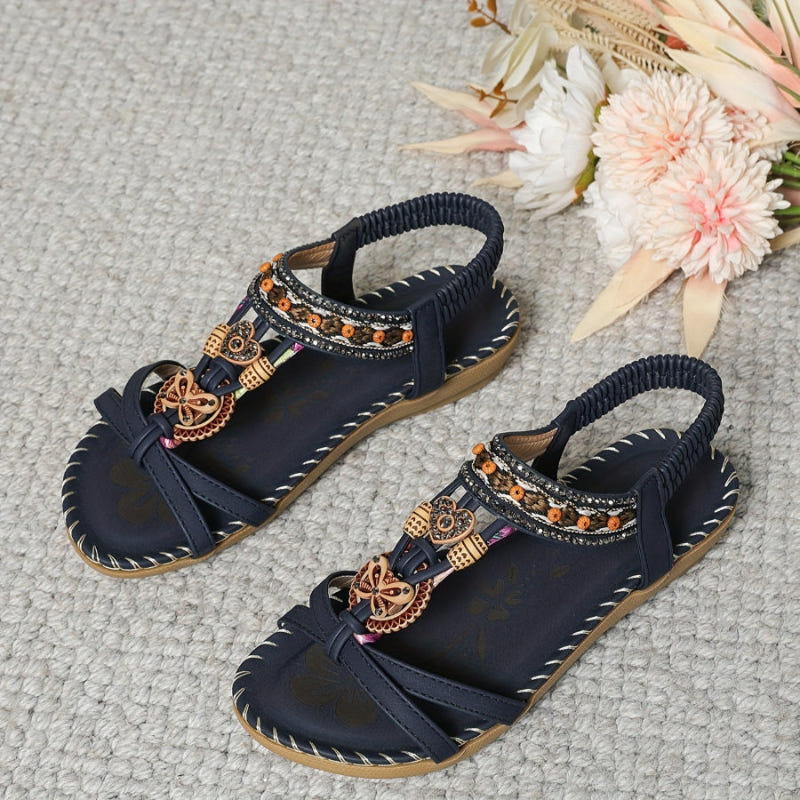 Navy beaded sandals with rhinestone straps, elastic fit, bronze ornament accents
