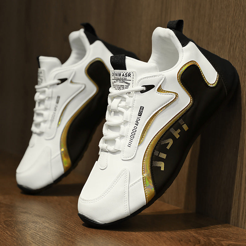 White sneakers with black and gold accents on a wooden surface