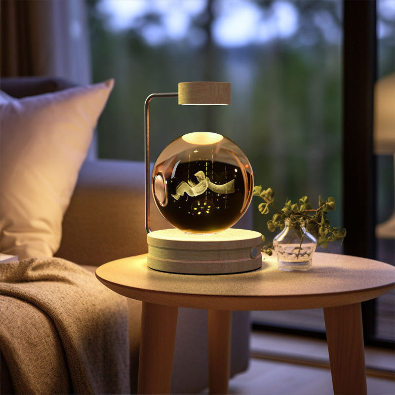 Crystal ball LED night light glowing inside clear glass dome on round wood base