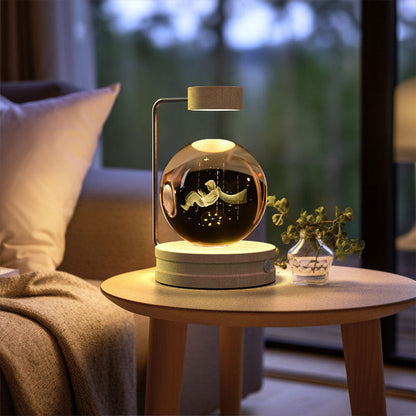 Crystal ball LED night light glowing inside clear glass dome on round wood base