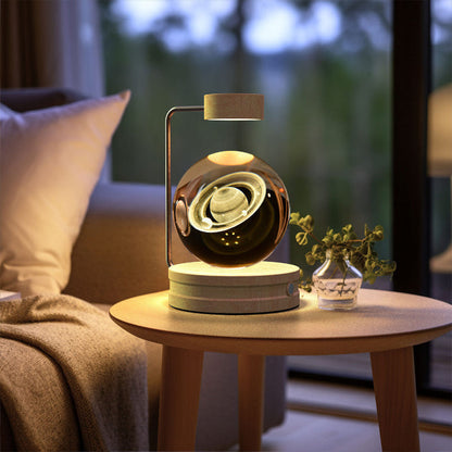 Crystal ball LED night light showing bright swirl glow in clear glass dome on wood base