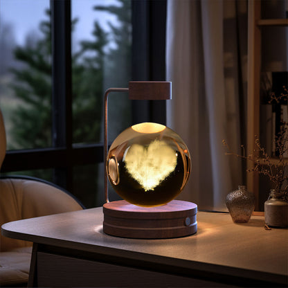 Glowing spherical lamp on a wooden table with a blurred indoor background