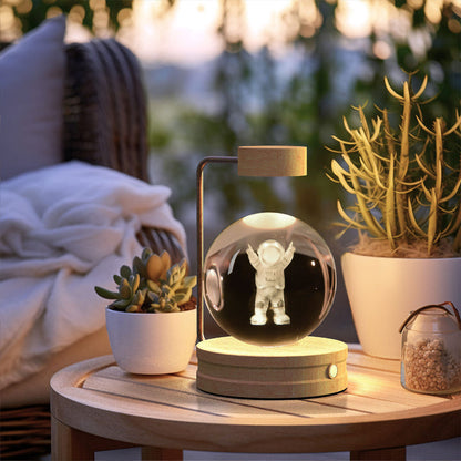 Cosmic LED night light with glowing astronaut figure inside clear crystal globe