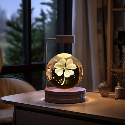 Decorative lamp with a four-leaf clover design on a wooden table.