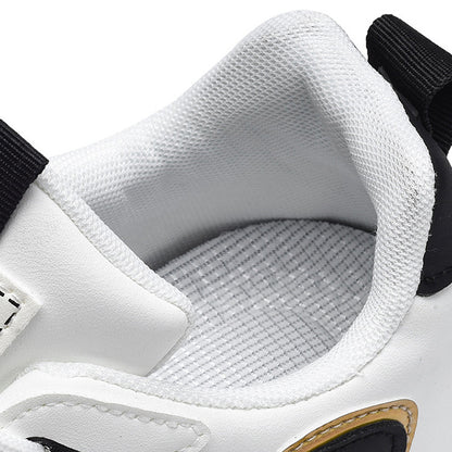 Close-up of a white sneaker with black accents and visible brand logo.