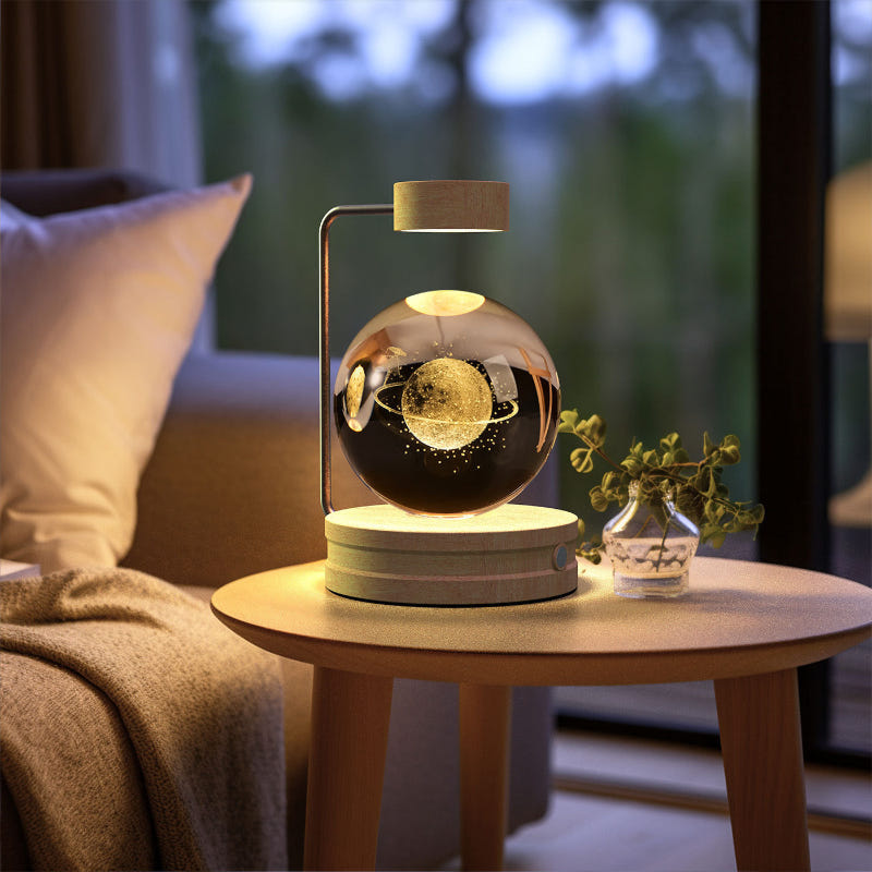 Crystal ball LED night light with bright golden glow inside clear glass dome on wood base