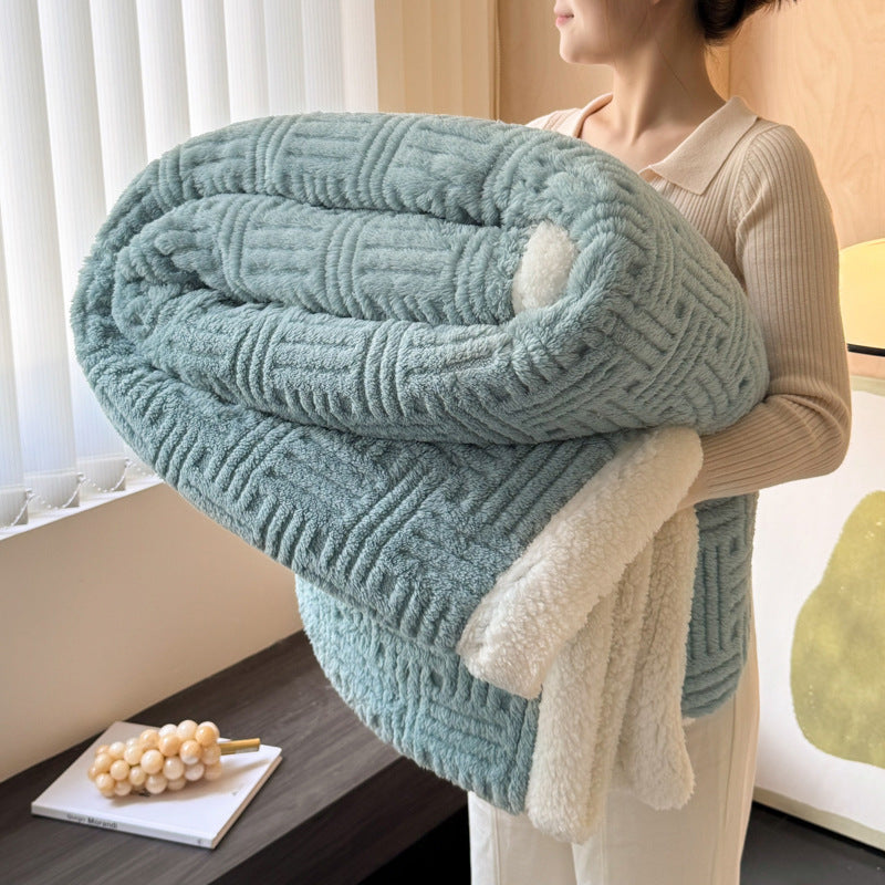 Person holding a light blue textured blanket indoors