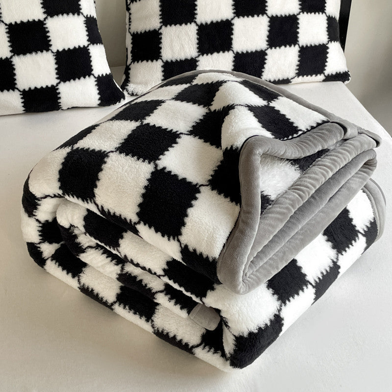 Black and white checkered blanket with gray edges on a chair