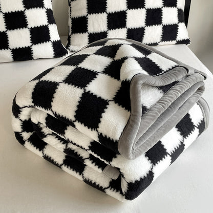 Black and white checkered blanket with gray edges on a chair