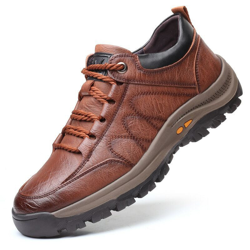 Brown leather shoe with orange laces on a white background