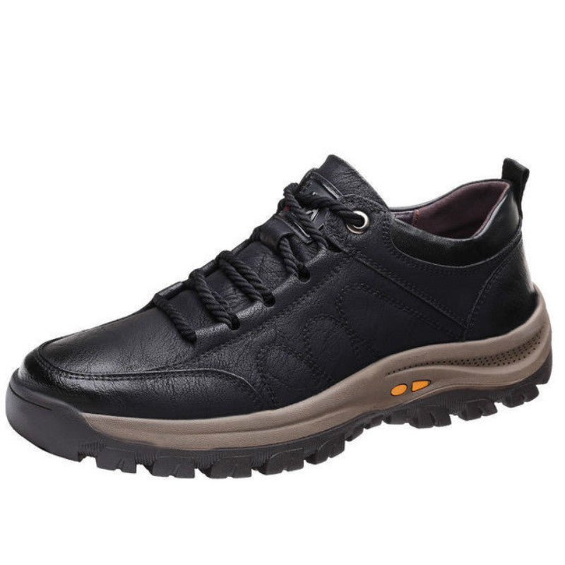 Black leather shoe with a brown sole on a white background