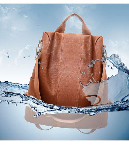 Brown PU leather tote-style backpack with two top handles and front zipper pocket