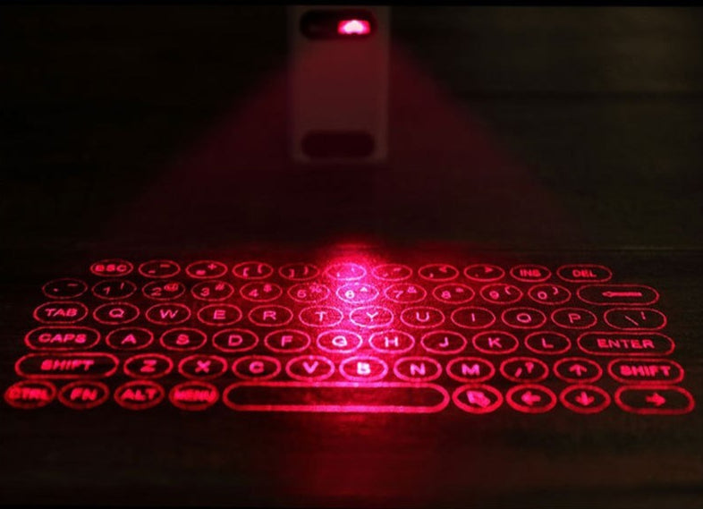 Red laser keyboard projected onto a dark surface with a phone in the background.