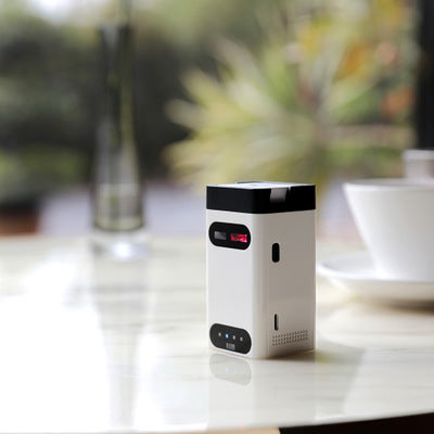 Small electronic device on a table with a blurred background
