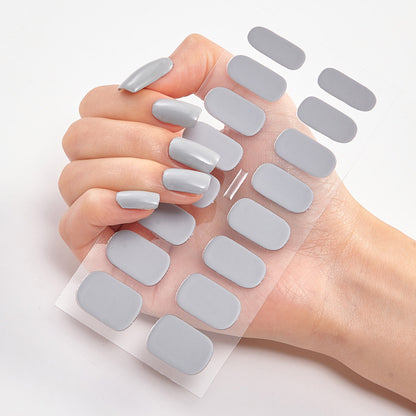 Hand with gray nail stickers on a white background