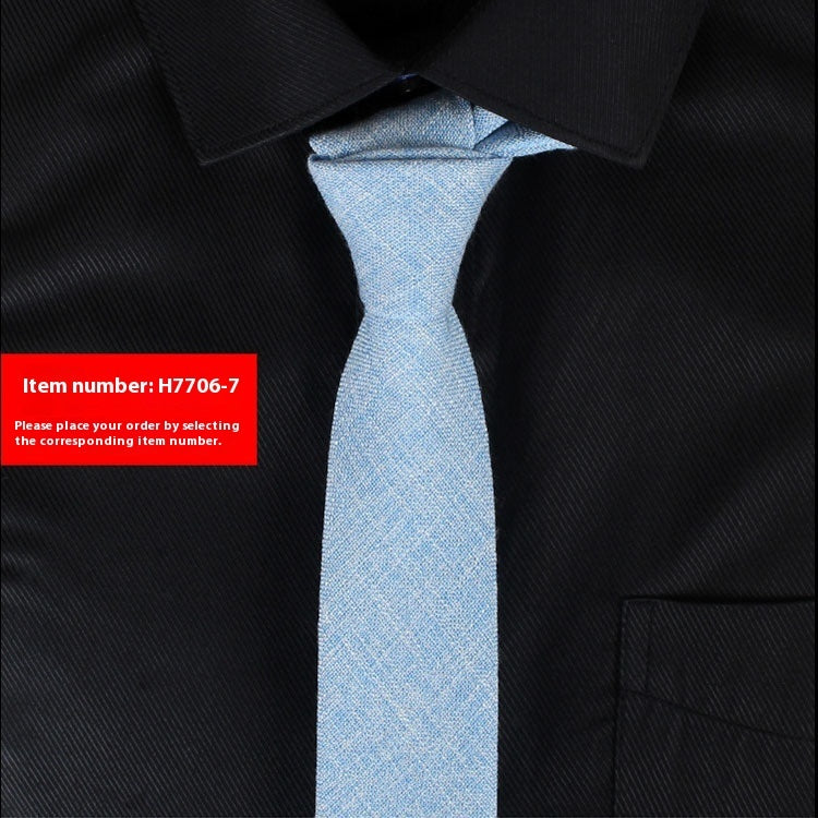 Black shirt with a light blue tie and a red item number label.