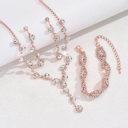 Rose-gold crystal jewelry set with necklace, earrings, and bracelet