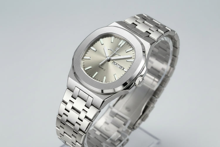 Silver watch with a metal bracelet on a beige surface, featuring a certificate of conformity.