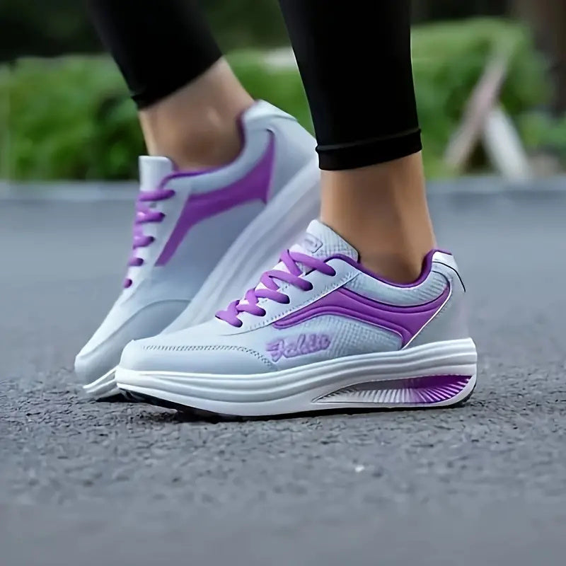 White and purple running shoes on a blurred outdoor background