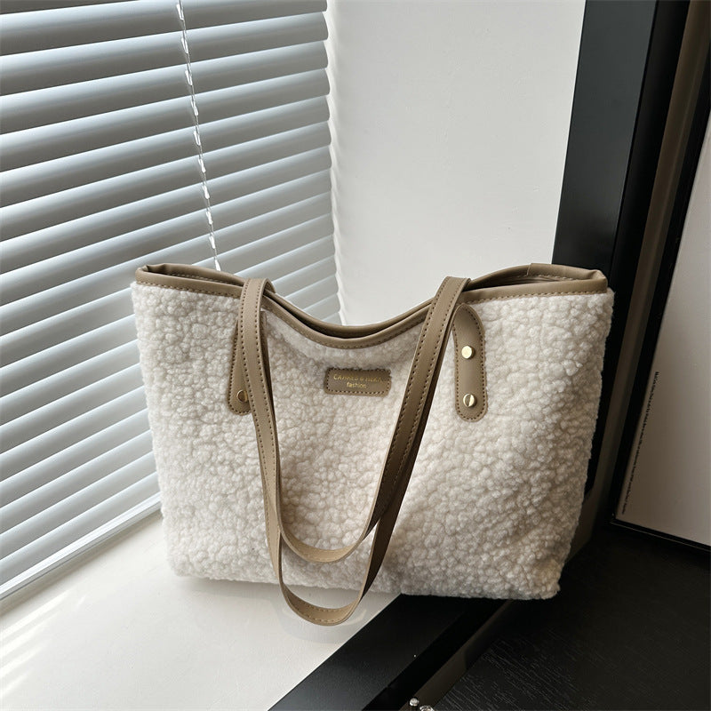 White furry tote shoulder bag with dual handles and small front patch label