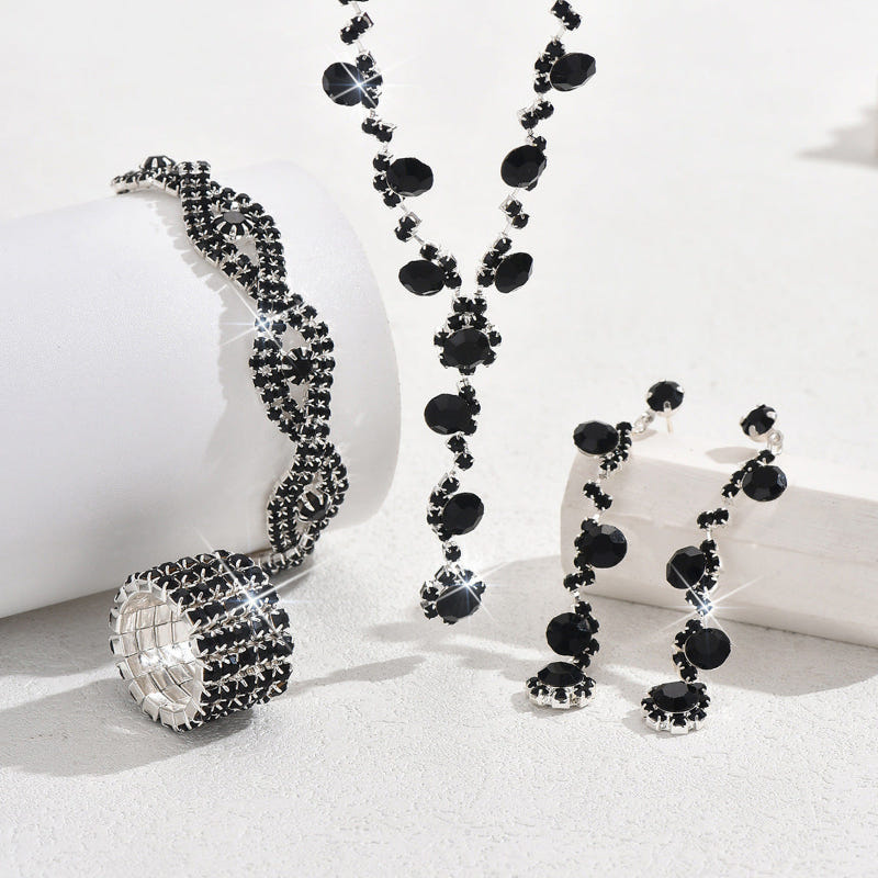 Black crystal necklace with charm pendant, matching bracelets, earrings, and ring set