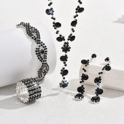 Black crystal necklace with charm pendant, matching bracelets, earrings, and ring set