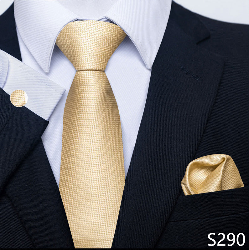 Gold tie and pocket square set with a black suit and white shirt.