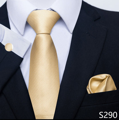 Gold tie and pocket square set with a black suit and white shirt.