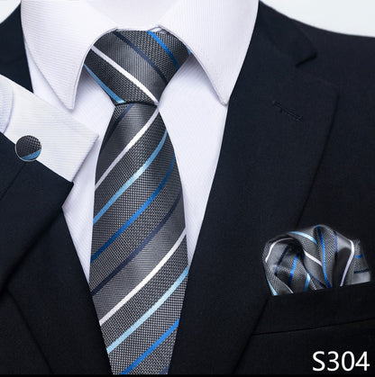 Black suit with a striped tie and matching pocket square on a white background