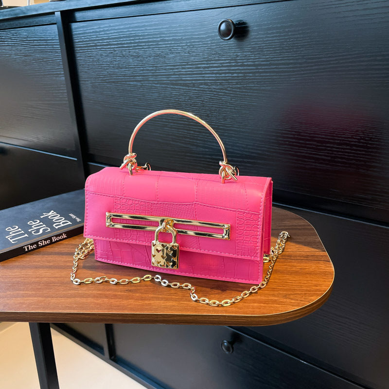Women’s chain crossbody bag in bright pink PU leather with gold-tone lock charm and chain