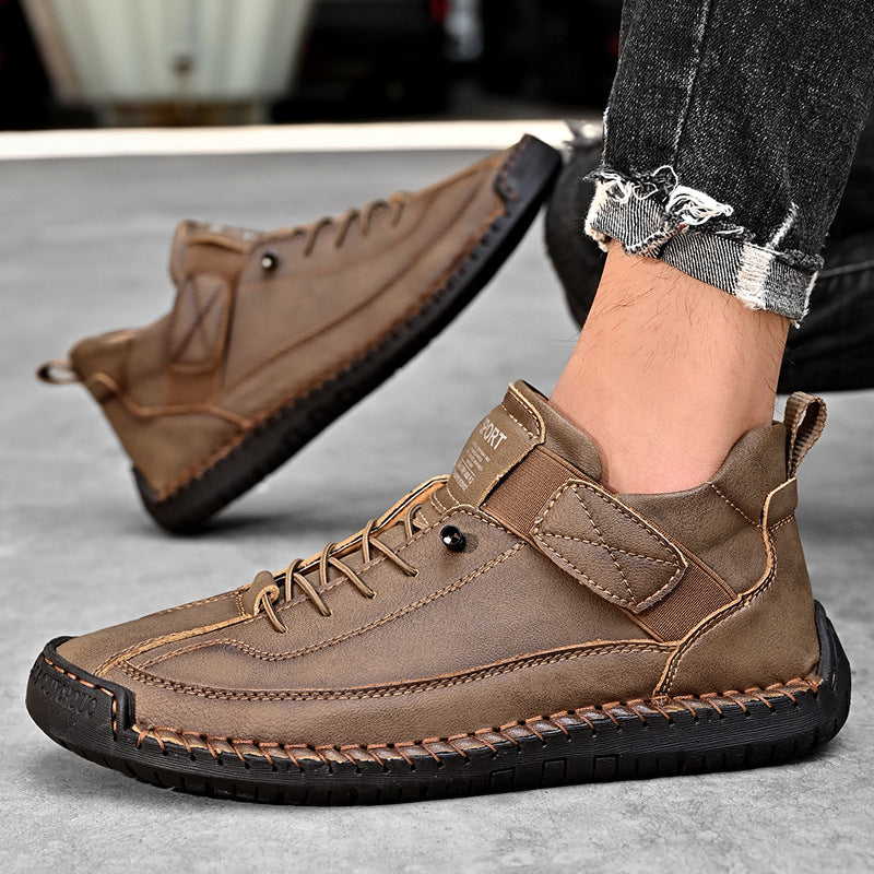 Men's mid-top leather lace-up shoe in tan with stitched seams and dark rubber sole.