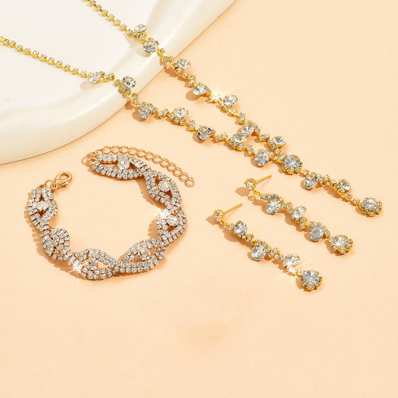 Gold-tone crystal necklace and bracelet set with matching hoop earrings and ring