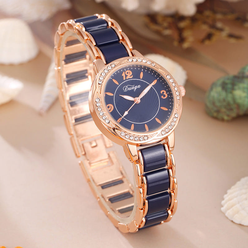 Rose gold round quartz wristwatch with dark blue dial and black link bracelet