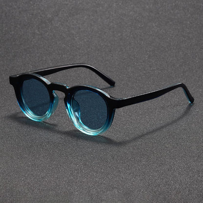 Sunglasses with black frames and blue-tinted lenses on a gray background