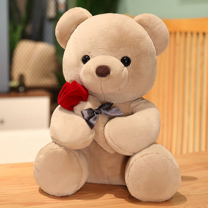 Beige teddy bear with a red rose and black bow. YAXSO UAE ONLINE STORE